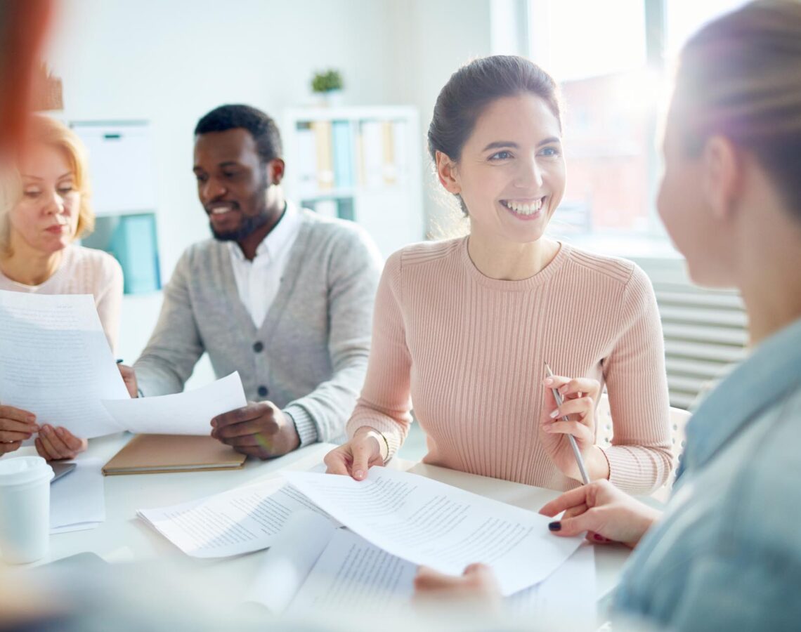 a woman speaking with a colleague during a meeting