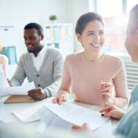a woman speaking with a colleague during a meeting