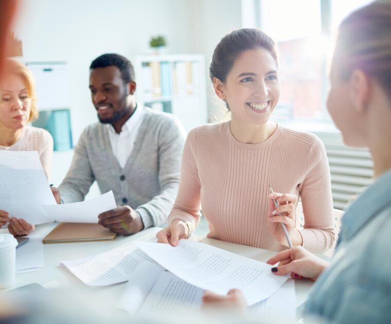 a woman speaking with a colleague during a meeting