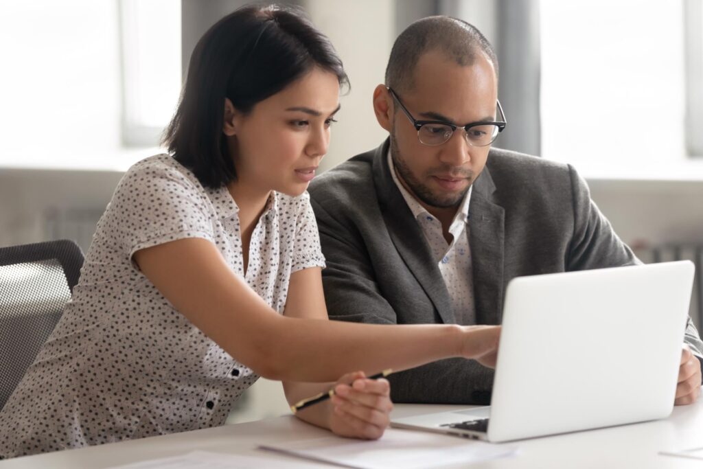 two colleagues working on a laptop