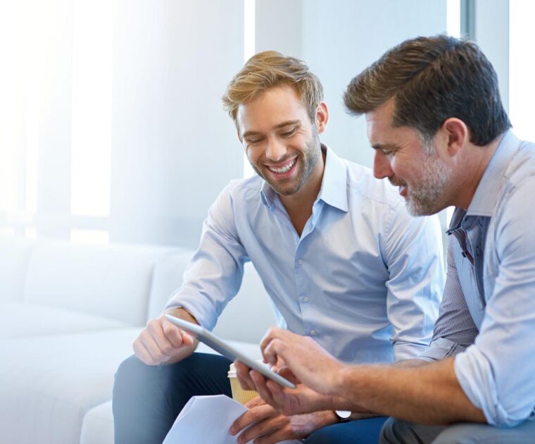 two colleagues working on a tablet computer