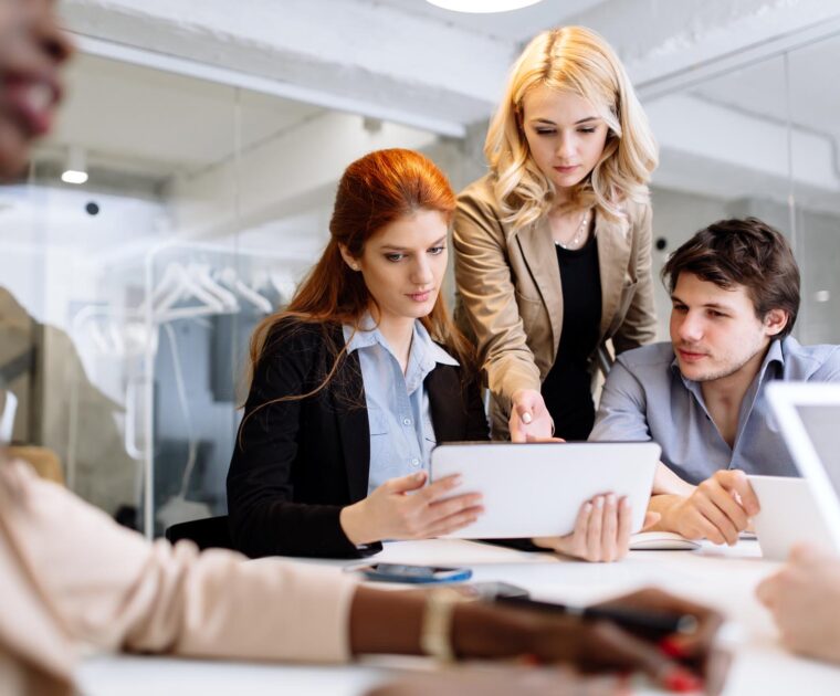 a worker upskilling colleagues using a tablet