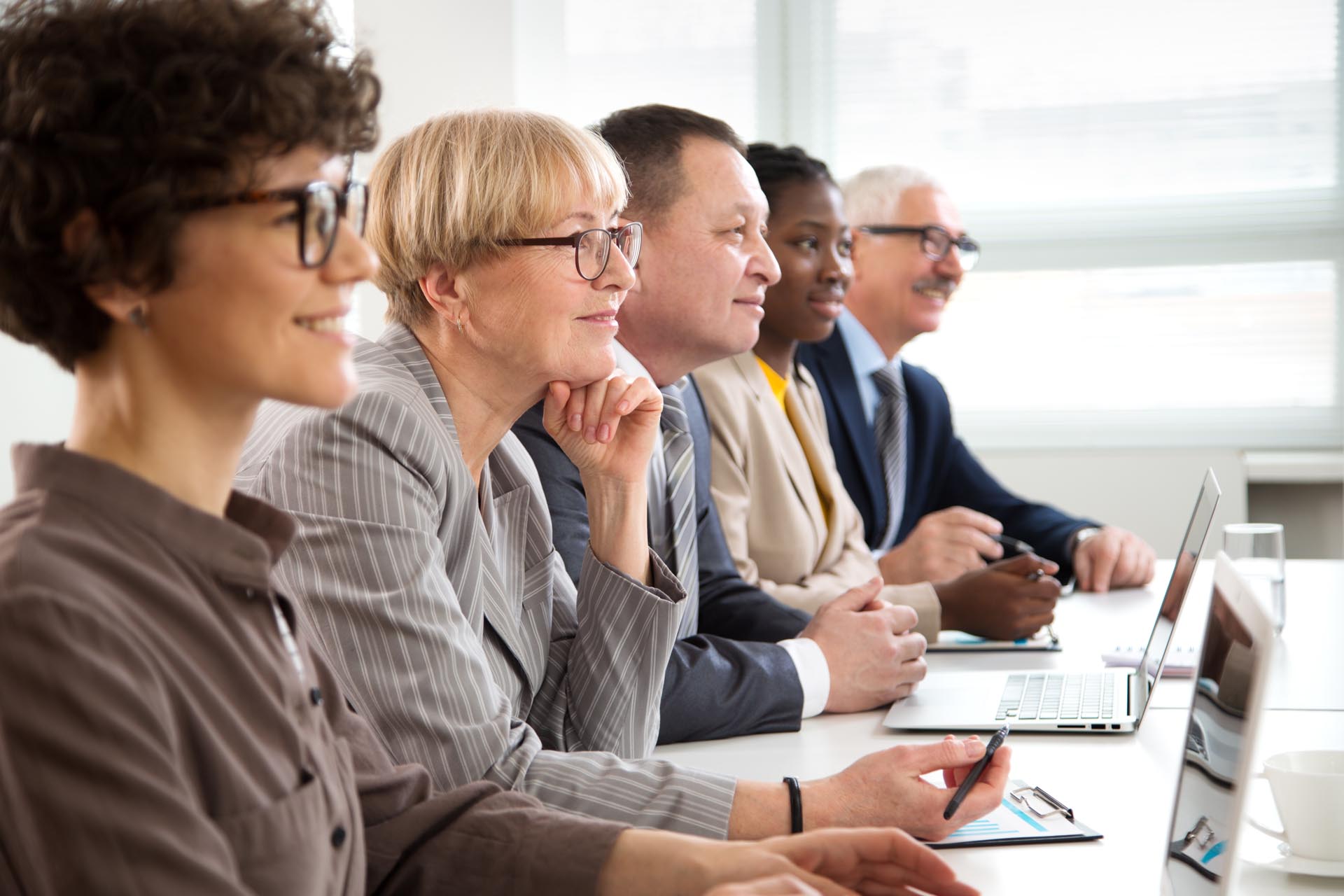 group of workers listening to a presentation