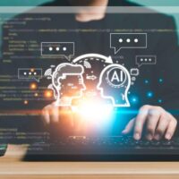 ai and human icons over a laptop screen