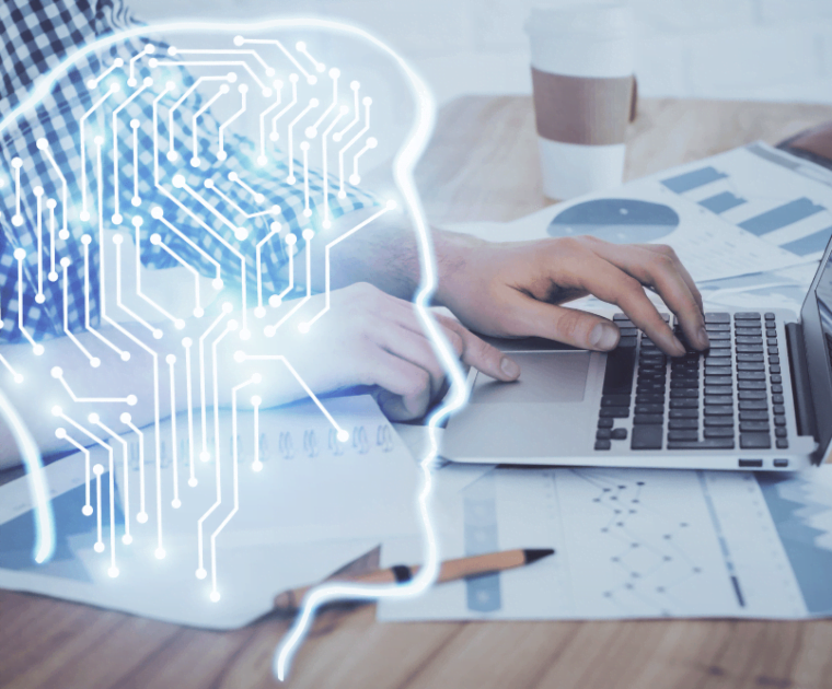 ai icon on top of someone working on a laptop