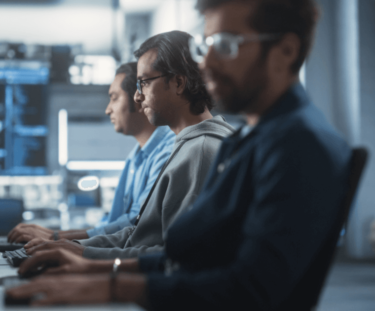 three consultants working on laptops