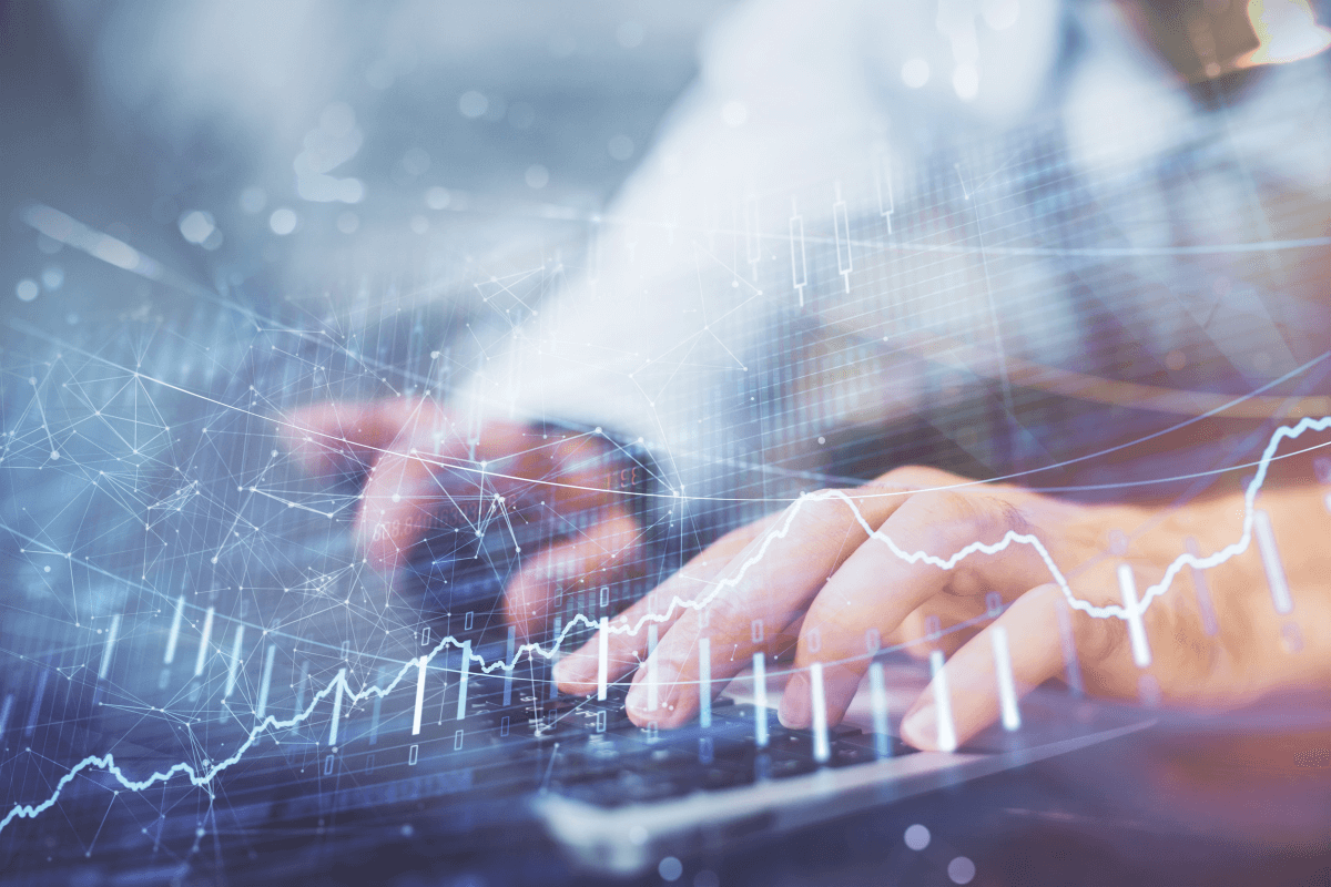 many using a keyboard with graphs overlayed over his hands