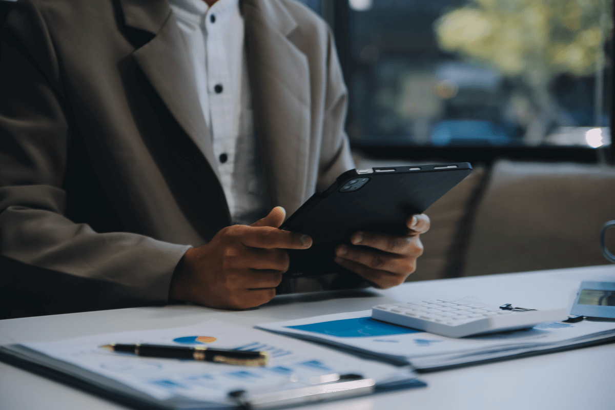 man at desk using a tablet